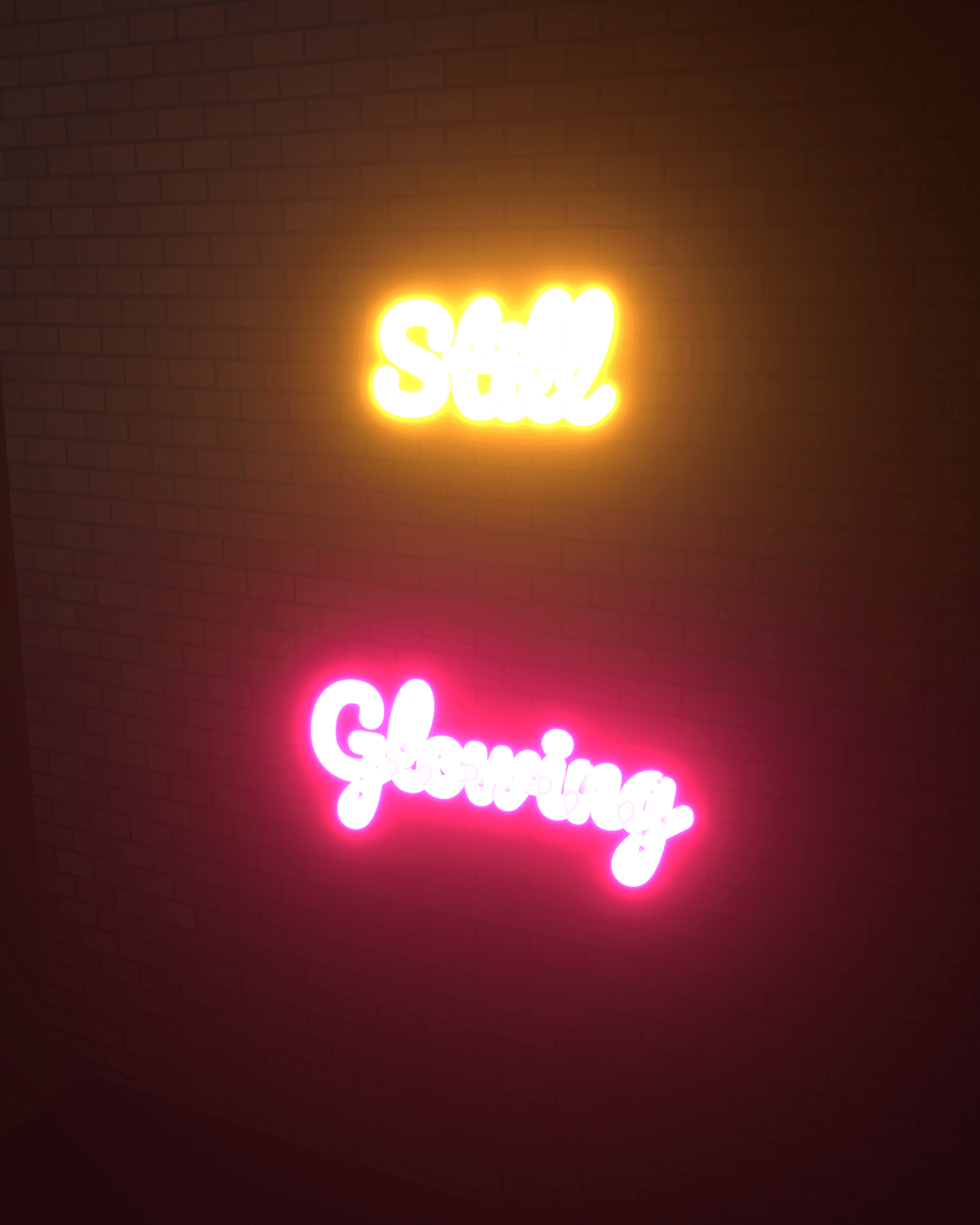 Still Glowing, a script neon sign built from a real glass tube, amber word above a pink/ruby word, mounted on a dim brick wall with real glow bleeding onto the brick