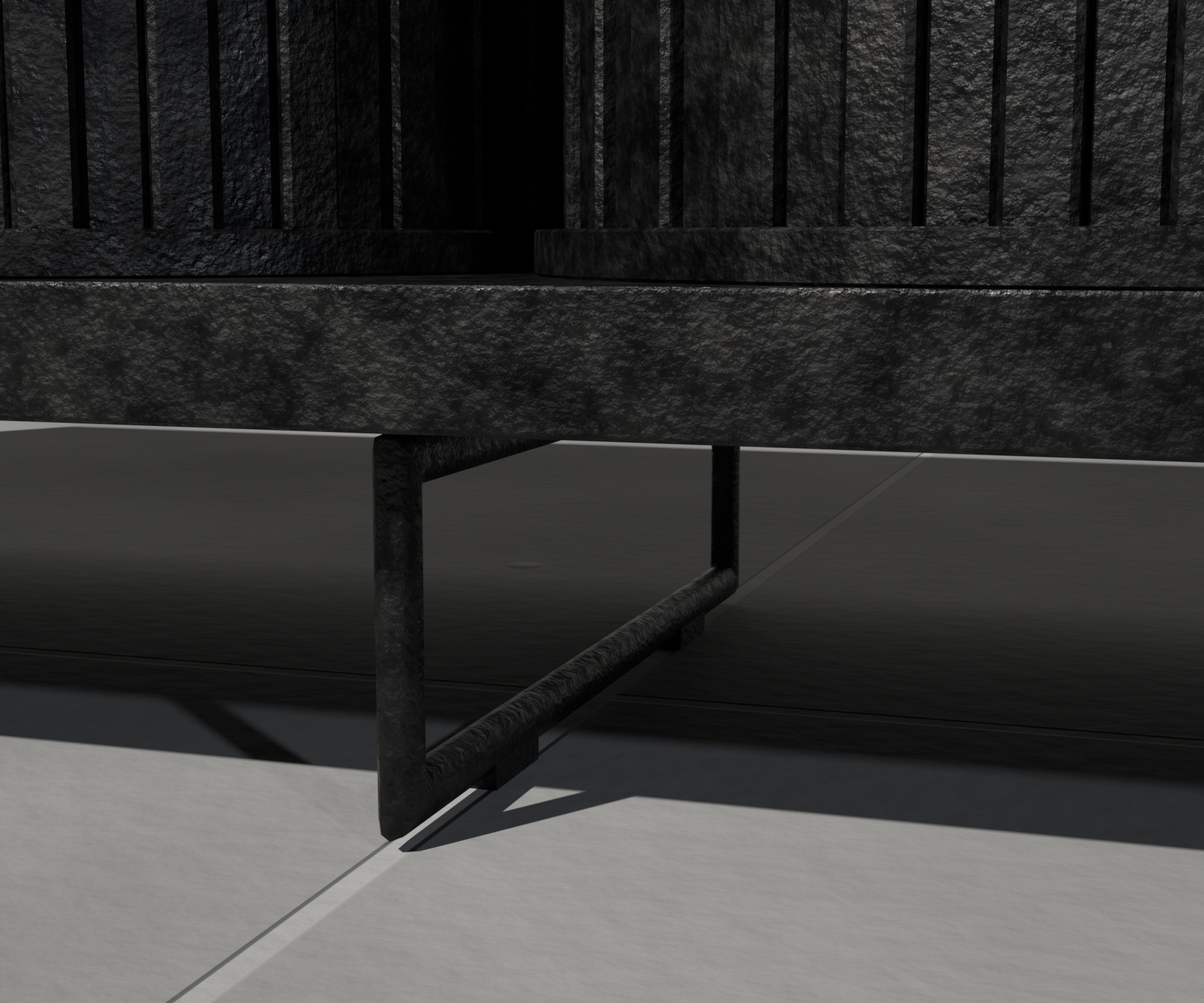Close detail of the CAST leg and body joint, raw cast iron standing on a rough poured-concrete floor