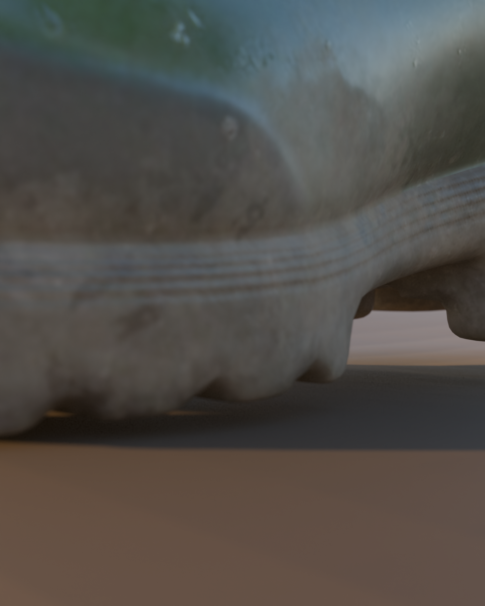 Macro detail of the TERRA TX-1 lugged tread and welt seam, real mud caught in the lug channels, green rubber upper visible above